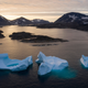 Icebergs float away as the sun rises near Kulusuk, Greenland in August 2019.